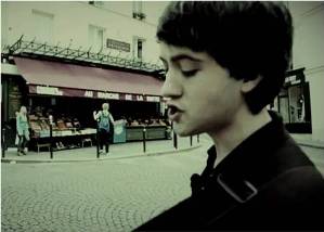 Conor O'Brien of Villagers busking in front of Amelie's greengrocer, Abbesses, Montmartre, Paris, France (Still image from video by Le Hiboo)