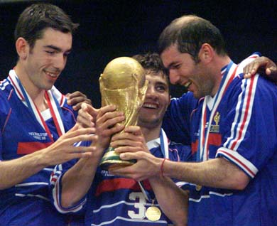 Robert Pires, Bixente Lizarazu and Zinedine Zidane celebrate with the World Cup
