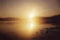 A sunrise over a lake with Peyote nowhere to be seen